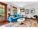 Cozy living room featuring a blue sectional, plush rug, and ample natural light at 3145 W 31St Ave, Denver, CO 80211