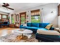 Inviting living room with a blue sectional sofa, stylish decor, and lots of natural light from the windows at 3145 W 31St Ave, Denver, CO 80211