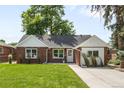 Inviting brick home features a lush green lawn and a charming exterior design, perfect for curb appeal at 2635 Kearney St, Denver, CO 80207