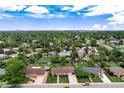 An aerial image displaying the property's neighborhood with abundant green trees and distant cityscape at 6666 S Pennsylvania St, Centennial, CO 80121