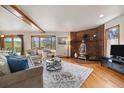 Cozy living room with hardwood floors, brick fireplace, and a bay window at 77 Krestview Ln, Golden, CO 80401