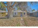 Cute bungalow home with a tree-lined front yard at 3348 S Corona St, Englewood, CO 80113