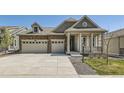 Charming home with stone accents, covered porch and an attached two car garage at 15788 Valentia St, Thornton, CO 80602