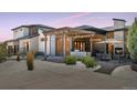 Inviting backyard patio area with pergola, outdoor fireplace, and dining space at 6915 Tremolite Dr, Castle Rock, CO 80108