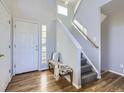 Inviting foyer featuring hardwood floors, a staircase, and natural light streaming through a window at 15047 E 50Th Dr, Denver, CO 80239