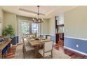 Inviting dining room with a wooden table set for a meal, bathed in natural light from the French doors at 15976 Quarry Hill Dr, Parker, CO 80134