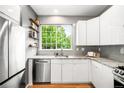 Bright, modern kitchen featuring stainless steel appliances and granite countertops at 1947 King St, Denver, CO 80204