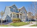 Inviting two-story home with a covered front porch and well-kept lawn and landscaping at 806 Cabot Dr, Erie, CO 80516