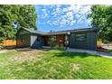 Charming single-story home with a well-manicured lawn and modern exterior accents at 5601 E Colorado Ave, Denver, CO 80224