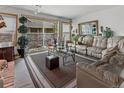 Bright living room with sliding door access to outdoor area, plush seating, and stylish decor at 4825 S Ammons St # 113, Littleton, CO 80123
