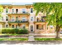 Charming apartment building featuring multiple balconies, well-maintained landscaping, and a welcoming entrance at 1100 N Logan St # 9, Denver, CO 80203