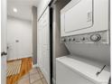 Convenient laundry area with a stackable washer and dryer, plus extra storage space behind sliding doors at 1100 N Logan St # 9, Denver, CO 80203