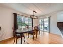 Inviting dining room featuring a large window and glass door providing abundant natural light and backyard views at 17148 E Evans Dr, Aurora, CO 80013