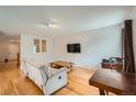 Bright living room boasting hardwood floors, offering a versatile space for relaxation and entertaining at 17148 E Evans Dr, Aurora, CO 80013