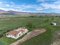 Exterior view of home and land surrounded by large open fields with mountain views at 8602 N 39Th St, Longmont, CO 80503