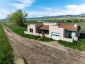 Charming single-story home featuring attached garage, mountain views and open fields at 8602 N 39Th St, Longmont, CO 80503