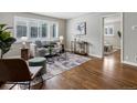 Sunlit living room boasts hardwood floors, neutral décor, and bright window with white shutters at 2047 S Milwaukee St # 4, Denver, CO 80210