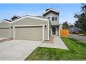 Modern two-story townhome with attached garage and landscaped lawn at 5232 Columbine Ln, Denver, CO 80221