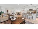 Open living room showcasing modern furniture and a kitchen with island at 5232 Columbine Ln, Denver, CO 80221