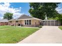 Beautiful home featuring a brick facade, well-maintained lawn, and convenient driveway leading to a detached garage at 585 Estes St, Lakewood, CO 80226