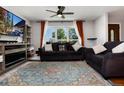 Comfortable living room with plush sofas, a ceiling fan, and a large window offering ample natural light at 585 Estes St, Lakewood, CO 80226