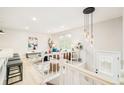 Inviting living room featuring modern decor, stylish lighting, and a staircase at 2988 S Hannibal St, Aurora, CO 80013