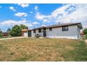 Charming single-story home features a well-maintained lawn, painted white brick, and a dark brown roof at 7150 Beach St, Westminster, CO 80030