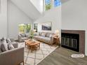 Bright living room with vaulted ceiling, modern furniture, fireplace, and ample natural light showcasing a comfortable design at 6731 S Ivy Way # B4, Centennial, CO 80112