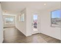 Bright and airy entryway with hardwood floors and view into the living area at 15243 W 69Th Ave, Arvada, CO 80007