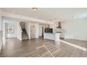 Open concept kitchen with island, stainless steel appliances, and hardwood floors at 15243 W 69Th Ave, Arvada, CO 80007