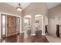 Inviting foyer with hardwood floors, high ceilings, and a decorative wooden door at 20097 Royal Troon Dr, Monument, CO 80132