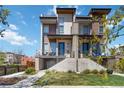 Modern townhome featuring a sleek design with balconies and professionally landscaped yard at 2409 Court Pl, Denver, CO 80205