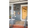 Close-up of the front door with house number, stylish design, and tiled porch at 4824 Knox Ct, Denver, CO 80221