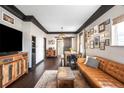 Cozy living room with hardwood floors, leather sofa, and stylish decor at 4824 Knox Ct, Denver, CO 80221