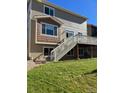 Two story home with deck and stairs leading to backyard at 21383 E Smoky Hill Rd, Centennial, CO 80015