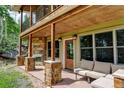 Cozy patio with stone columns, fireplace, and comfortable seating, ideal for outdoor lounging and relaxation at 1555 Three Peaks Rd, Golden, CO 80403