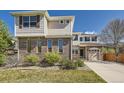 Attractive two-story home featuring brick accents, siding, a well-maintained lawn, and an attached garage at 24763 E Crestridge Pl, Aurora, CO 80016