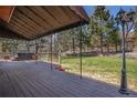 Large deck with awning, perfect for outdoor gatherings, featuring a hot tub and expansive lawn at 7965 Lakeshore Dr, Parker, CO 80134