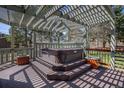 Relaxing outdoor space with a hot tub nestled under a pergola, creating a private retreat at 7965 Lakeshore Dr, Parker, CO 80134
