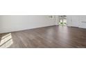 Bright living room featuring wood-look flooring, white walls, and natural light at 681 N Tempe St, Aurora, CO 80018