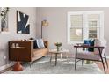 Bright living room featuring modern furnishings, stylish décor, and a large window at 4280 S Pearl St, Englewood, CO 80113