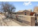 Street view of a brick home with a decorative fence and landscaping in the front at 1185 Worchester St, Aurora, CO 80011