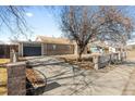 A single-story brick home featuring a paved driveway and decorative wrought iron fence at 1185 Worchester St, Aurora, CO 80011