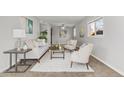 Bright living room with modern furnishings, neutral tones, and ample natural light at 1185 Worchester St, Aurora, CO 80011