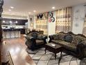 Elegant living room featuring ornate furniture, decorative curtains, and hardwood floors, perfect for entertaining guests at 15600 Bolling, Denver, CO 80239