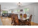 Open-concept dining area with hardwood floors, classic furniture, and a seamless flow into the cozy living room at 6031 S Pennsylvania St, Centennial, CO 80121
