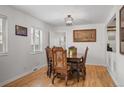 Bright dining room boasts hardwood floors, classic furniture, and ample natural light, perfect for Gathering gatherings at 6031 S Pennsylvania St, Centennial, CO 80121