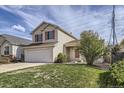 Charming two-story home featuring red shutters, a two-car garage, and a well-maintained front yard at 22030 Hill Gail Way, Parker, CO 80138