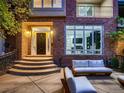 Inviting front porch with stylish seating, brick facade, and a modern glass-paneled entryway at 338 Saint Paul St, Denver, CO 80206