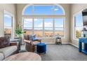 Bright living room featuring a large arch window overlooking a beautiful landscape at 3603 Soaring Eagle Ct, Castle Rock, CO 80109
